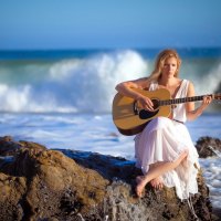 girl with guitar in the ocean