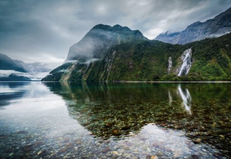 mountains over a shallow sea - clouds, waterfalls, mountains, stones, sea