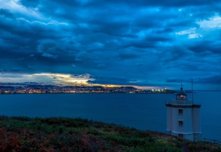 beacon on the bay - clouds, lighthouse, lights, dusk, city, bay