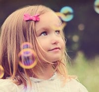 girl playing with bubbles