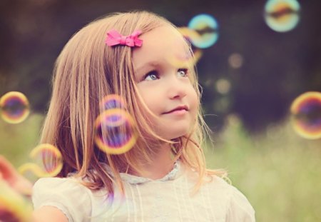 girl playing with bubbles