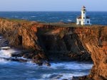 lovely lighthouse on a rocky coast point