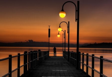 beautiful pier in golden dusk - person, sea, dusk, golden, pier, lamps