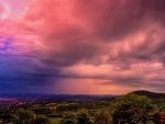 wonderful red clouds over city down the hills