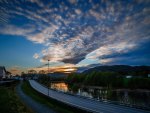 road along a river in suburbia at sunset