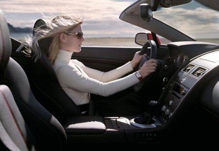 woman driving Aston Martin Vantage Roadster