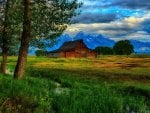 beautiful barn on the plains by a mountain range