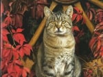 Tabby cat in front of wooden wheel