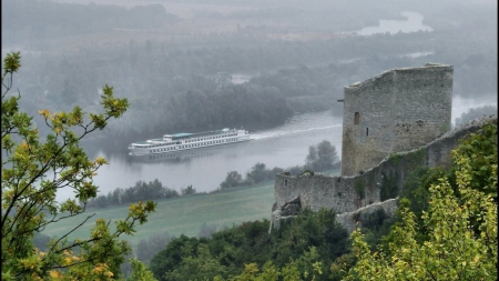 castle ruins above a river in france - ferry boat, hills, river, castle, mist