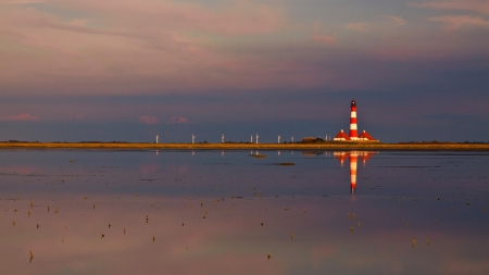 wonderful lighthouse among turbine windmills - lighthouse, reflection, windmills, shore, sea