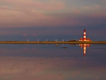 wonderful lighthouse among turbine windmills