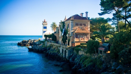 mansion by a lighthouse on a rocky seacoast - lighthouse, rocks, mansion, coast, trees, sea