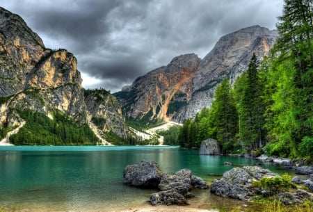 Lake Braies - quiet, Braies, blue, amazing, crystal, mountain, calmness, shore, cliffs, waters, lake, nice, emerald, sky, clouds, trees, Europe, beautiful, mirrored, lovely, peaks, stones, nature, Italy, clear, serenity, rocks