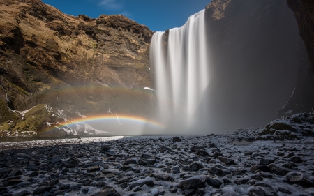 a rainbow at the base of a gorgeous waterfall - cliff, rainbow, pool, rocks, waterfall