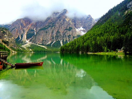 Boat in lake Braies - nice, sky, slope, italy, trees, water, clear, rocks, crystal, quiet, pretty, reflection, emerald, green, cliffs, boat, braies, lake, mountain, summer, shore, peaks, lovely, serenity, nature, beautiful