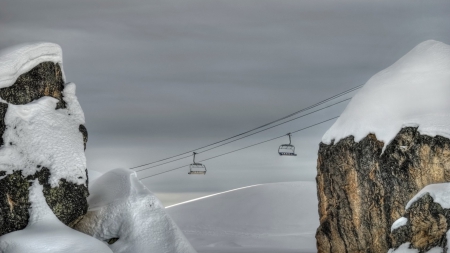 ski lift passing between two boulders - lift, ski, winter, boulders, cable