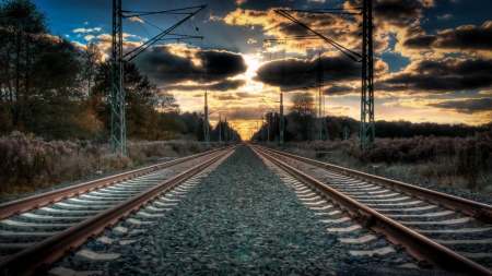 dual train tracks straight to a sunset - gtavel, clouds, electric, tracks, sunset