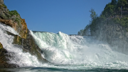 wild waterfall on the rhine in switzerland - view stand, cliff, waterfalls, mist, foam