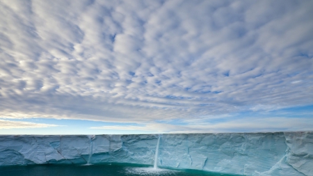 waterfall on a mighty glacier - ice, clouds, glacier, waterfall, sea