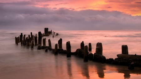 broken pier in a beautiful peach colored sea and sky - pier, beach, clouds, sunset, sea, pylons