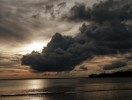 storm clouds hovering above a sea