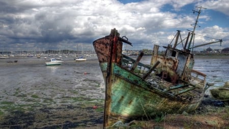 ship wreck at the edge of a low tide harbor - clouds, ship wreck, boat, harbor, low tide