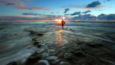 amazing sunset on a surfer walking on a rocky shore - shore, sunset, sea, rocks, surfer