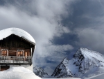 snow covered chalet up high in the mountains