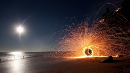 circular sparkler on a beach at night - cliff, sparkler, beach, moon, sea, round