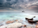 lighthouse on an island in a misty sea