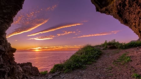 magnificent sunset through a coastal cave - cave, clouds, sunset, coast, sea