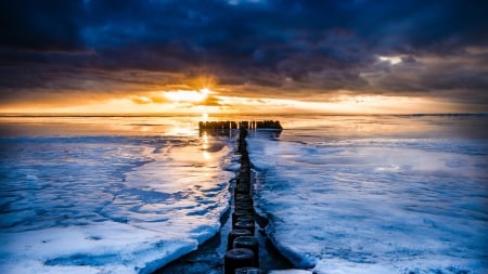 fabulous sunset on a row of pylons in the sea - clouds, winter, sunset, pylons, sea