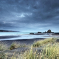 dunes on a beach under stormy skies