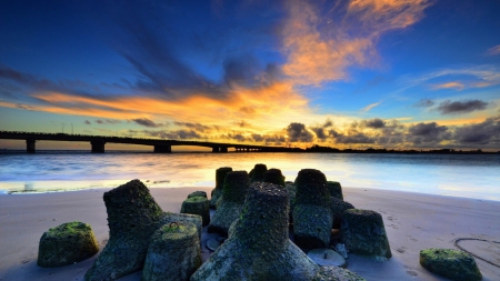 old cement breakers growing moss - breakers, clouds, sunset, beach, moss, bridge, bay