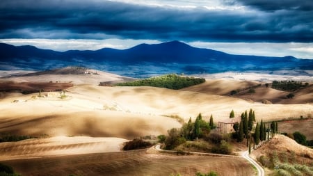 tuscan landscape in autumn - farms, mountains, hill, clouds, fields, trees