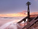 wharf on a beach in a soft sunset