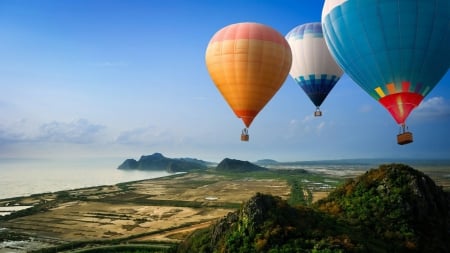 colorful hot air balloons over seacoast - coast, fields, balloons, sea, colors, mountain