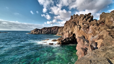 wonderful grotto in a rocky sea shore - clouds, grotto, shore, sea, rocks