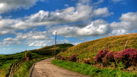 country road on a beautiful spring day - countryside, sky, road, fence, clouds, flowers, spring