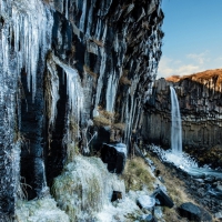 waterfall and icicles on formation cliff