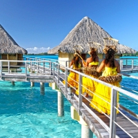 Intercontinental Thalasso Spa and Resort Bora Bora - Tahitian Girls walk on pontoon to water villas / bungalows