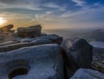 sunrise over mountain rocks with pools of water