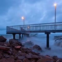 coastal pier on a stormy evening