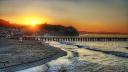 superb sunset over a seaside pier - hill, town, people, beach, pier, sunset, sea