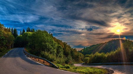 sunbeams over mountain road switchback - rays, forest, mountain, sun, switchback, road