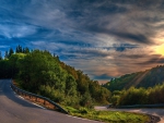 sunbeams over mountain road switchback