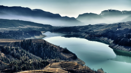 gorgeous rural lake scape - fog, fields, lake, mountains, farms