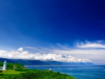 lighthouse on a wonderful green coastline