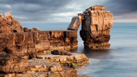 monument on a rocky sea shore - clouds, shore, monument, sea, rocks