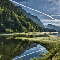 contrails above a beautiful river valley